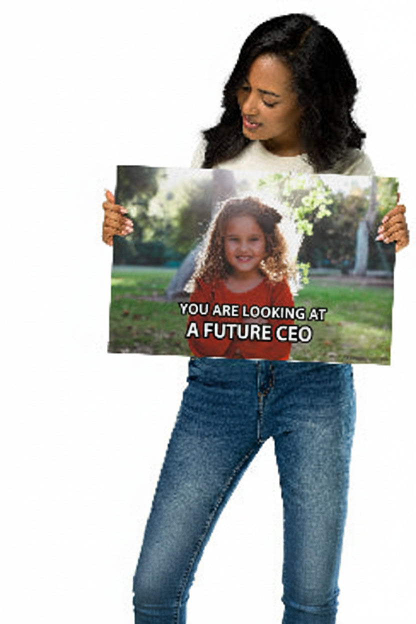 Woman holding a custom matte photo poster print with a personalized meme caption reading 'You are looking at a future CEO', example of the customizable canvas meme print